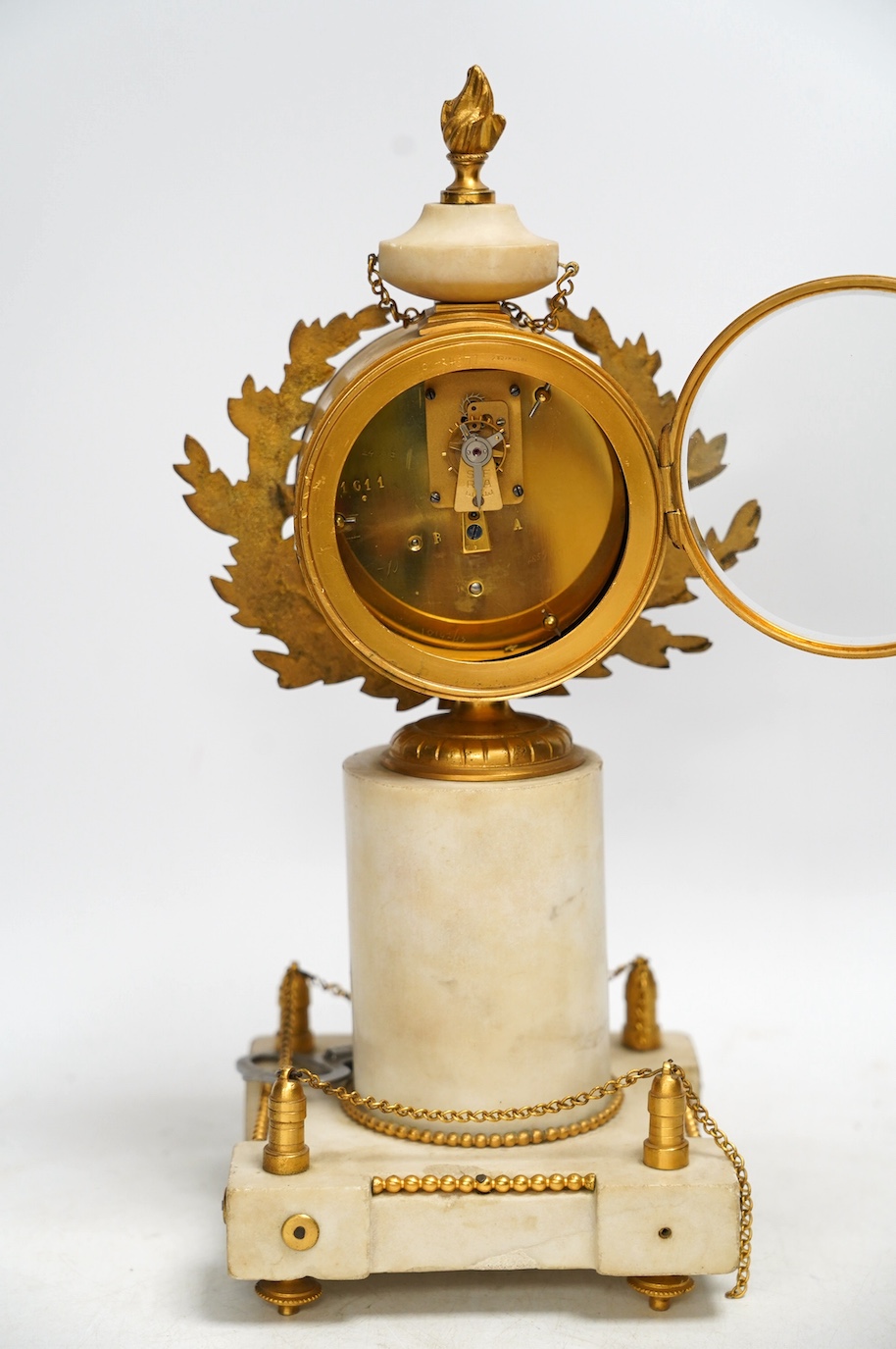 A late 19th century French alabaster and gilt metal timepiece with enamel dial, with key, 31cm high. Condition - fair